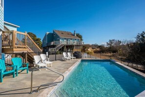 A swimming pool with lounge chairs and a deck area. - Duck Blind | Infinity Pool, Sound Views & Sauna (Duck)