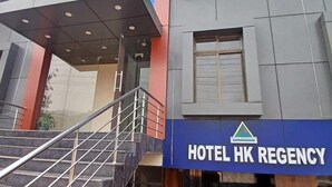 A modern building with a sign for Hotel HK Regency. - Hotel HK Regency (Guwahati)