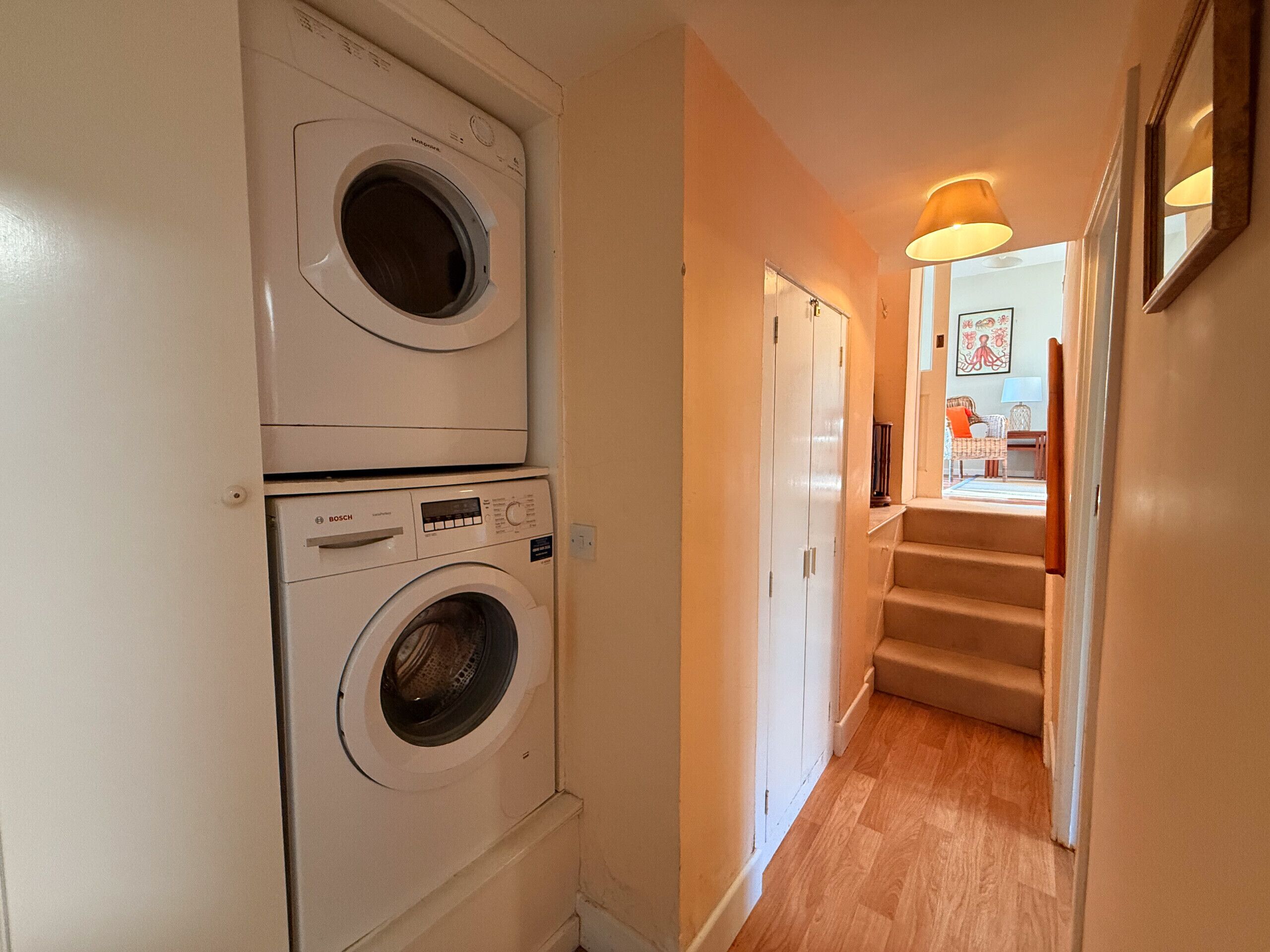 A laundry room with two stacked front-loading washing machines.