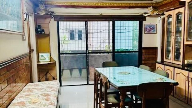 A dining area with a table and chairs, a bench, and a ceiling fan.