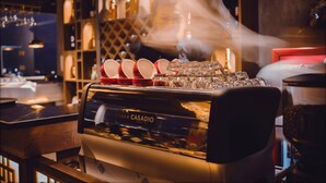 A bar area with a CASADIO espresso machine, glasses, and bottles. - Hotel Sherpani (Kathmandu)