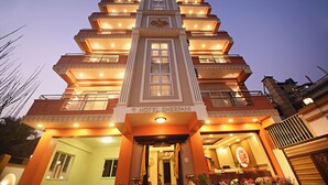 A multi-story hotel with a central entrance, balconies, and a sign reading "HOTEL SHERPANI". - Hotel Sherpani (Kathmandu)
