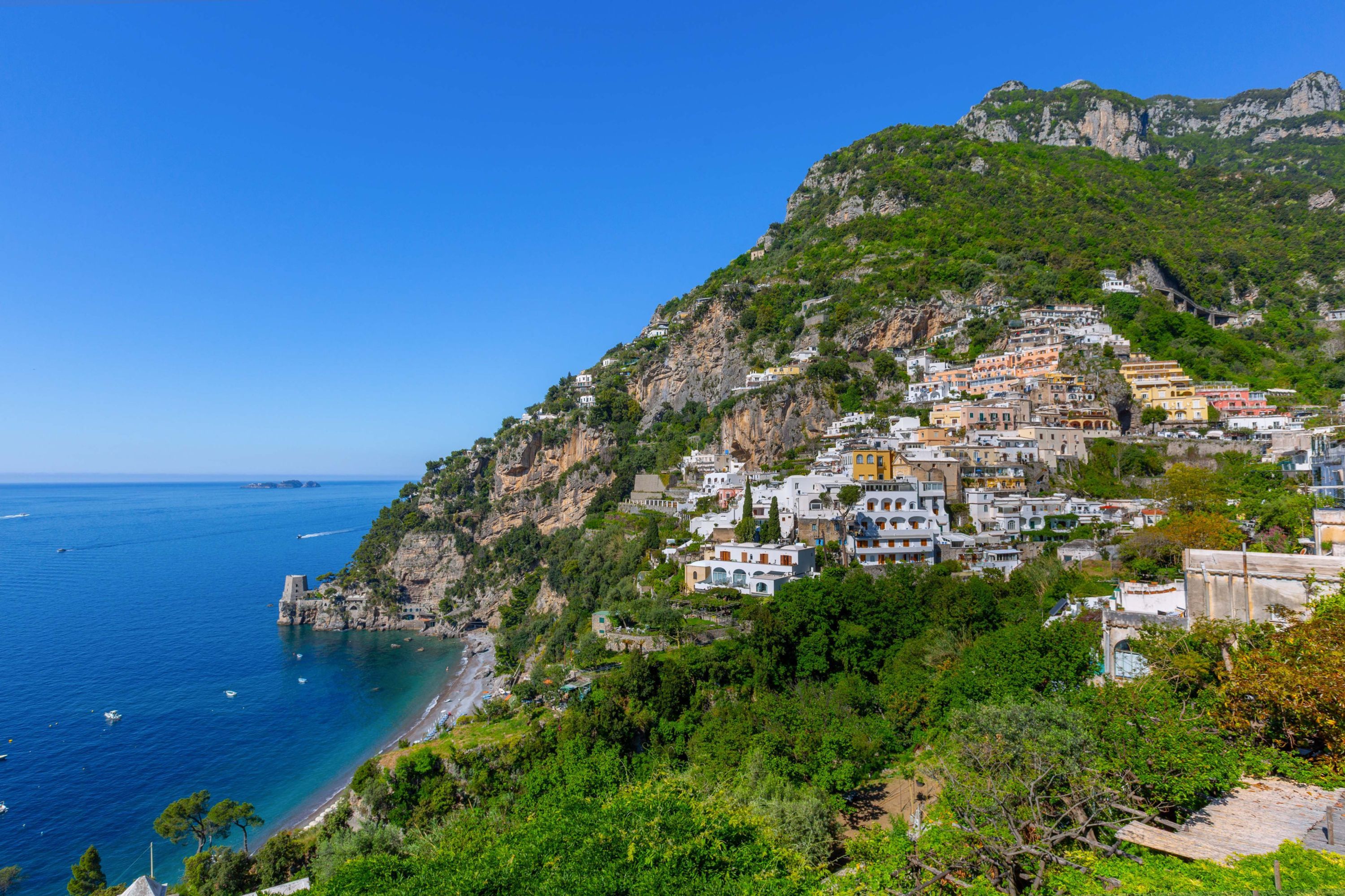 A coastal town with buildings on a hillside overlooking the sea.