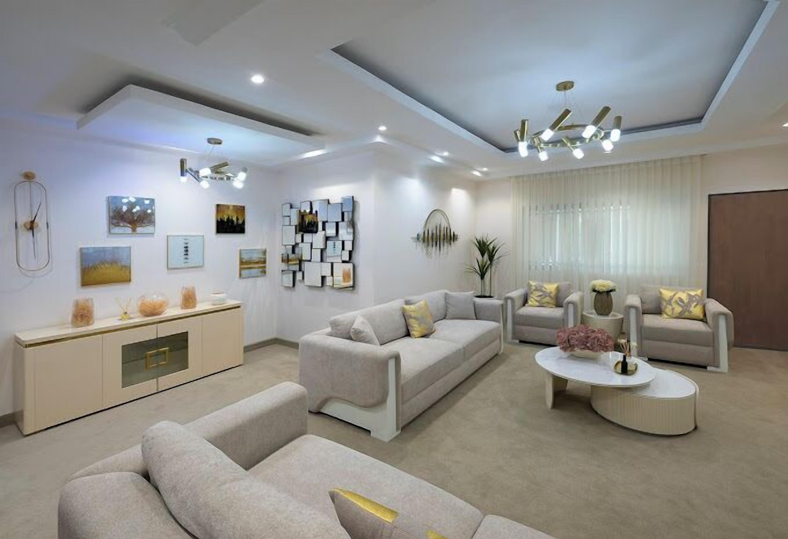 A modern living room with sofas, a coffee table, and wall art.