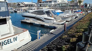 A marina with several boats docked, a prominent water tower, and a building labeled "Pirate Shop".