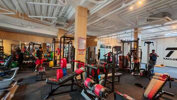 A gym with various exercise equipment, including weight machines and free weights.