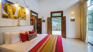 A bedroom with a large bed, a view to the outside, and artwork on the wall. - Margossa Residence Kandy - Two Bedroom Design Villa (Kandy)