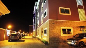 A multi-story hotel with a brick facade and multiple windows. - Fams Embassy Suites (Badagry)