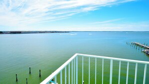 A view of a calm body of water with a dock extending into it.