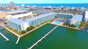 A modern hotel with a marina, featuring multiple buildings connected by walkways over water.
