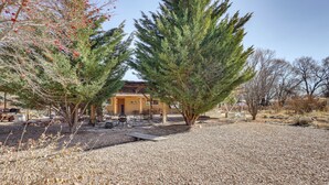 A building with a gravel driveway, surrounded by trees and dry vegetation. - Artsy Studio w/ Patio: 25 Mi to Santa Fe (Espanola)