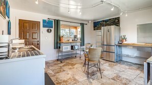 A compact kitchen with a dining area, featuring a microwave, refrigerator, and a small dining table with chairs. - Artsy Studio w/ Patio: 25 Mi to Santa Fe (Espanola)