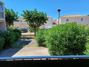 Zona residencial con casas, un camino pavimentado y un árbol.