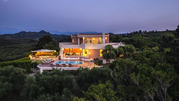 A modern two-story house with a swimming pool, surrounded by lush greenery and mountains in the background. - Villa Anastasia - Private Pool Panoramic Views (Platanias)