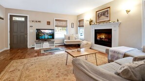 A living room with a fireplace, a television, and a sofa.