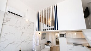A modern, compact living space with a kitchen, dining area, and a balcony with a view. - Villa Bono Romantic Suite & Private Jacuzzi (Saint-Laurent-du-Var)