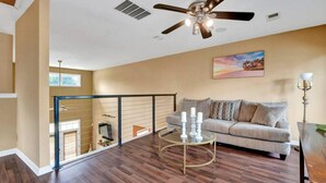 A living room with a sofa, a coffee table, and a ceiling fan. - Relax with the whole family at this peaceful place to stay. (Memphis)