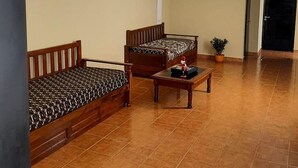A spacious living room with a sofa set, a coffee table, and a potted plant. - Hena Apart I (Esquel)