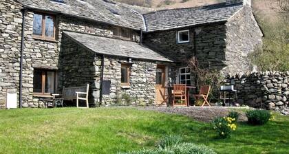 HARTSOP MILL COTTAGE, a cosy bijou hide-away surrounded by mountains