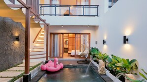A modern hotel interior with a swimming pool, a pink flamingo float, and a fish-shaped planter. - [Brand New] Serene Bali Villa w/ Private Pool – Tropical Escape in Canggu (Bali)