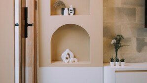 A bathroom with a white vanity, a stone wall, and a wooden door. - [Brand New] Serene Bali Villa w/ Private Pool – Tropical Escape in Canggu (Bali)