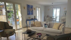 A living room with a sofa, armchairs, a coffee table, and a dining area with chairs and a table. - Uzès, 30 minutes from Mas d'Angel, at Éric & France (Cornillon)