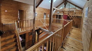 A wooden interior with a staircase, wooden railings, and skylights. - Large gîte for 14 people with hot tub & fireplace 🌲 Nature, forest & relaxation (raon sur plaine)