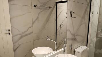 Bidet, towels, toilet paper