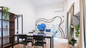 A modern dining area with a glass table, black chairs, and a wooden bookshelf. -  MOT Libertador 6300 A (Buenos Aires)