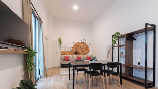 A modern living room with a sofa, dining table, chairs, and a bookshelf. -  MOT Libertador 6300 A (Buenos Aires)