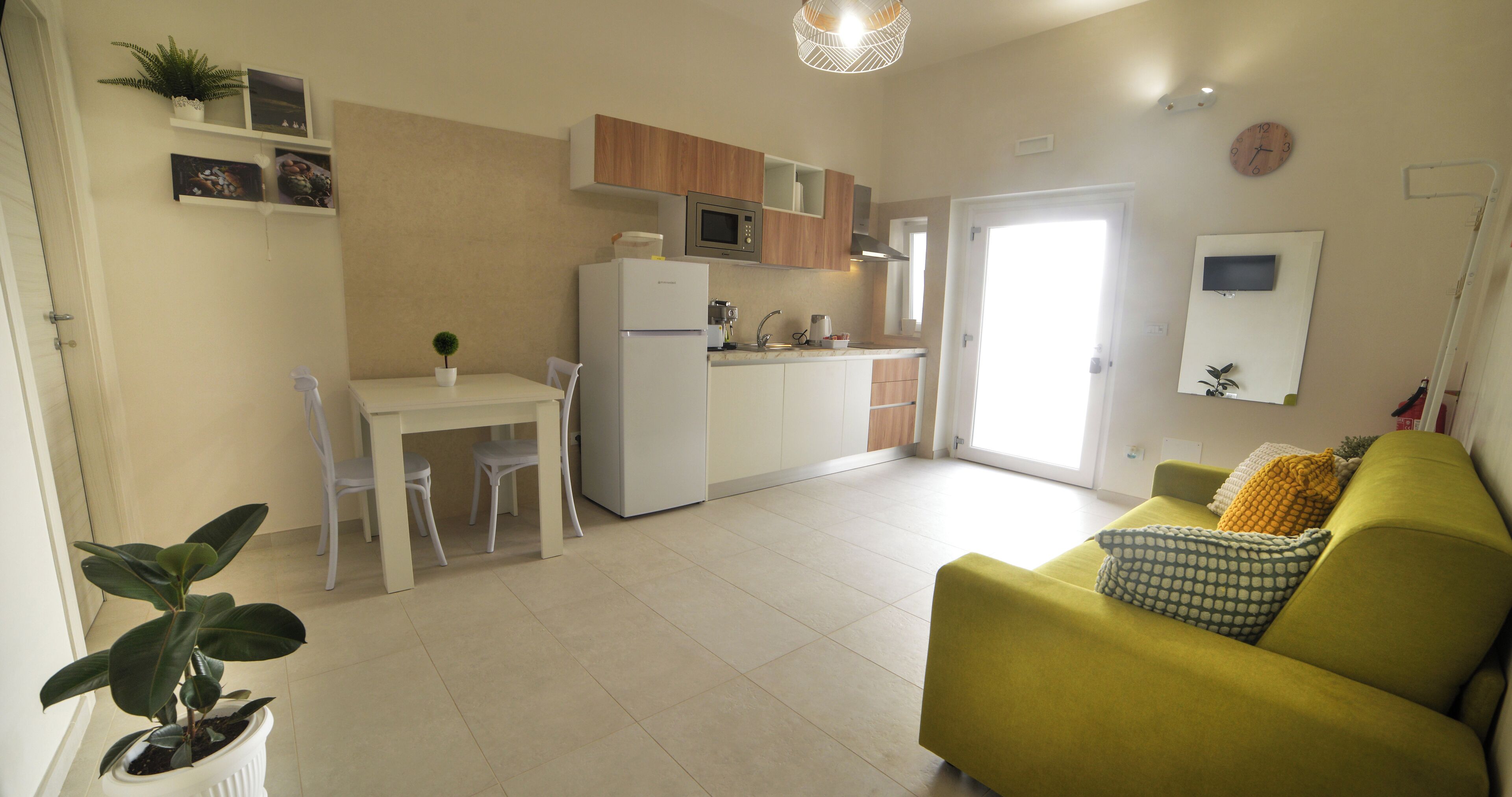 A modern apartment with a kitchen, dining area, and living room.