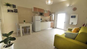 A modern apartment with a kitchen, dining area, and living room.