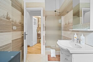 Shower, hair dryer, towels, toilet paper