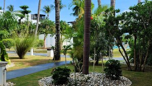 A landscaped garden with palm trees, a pathway, and a pool area. - Aligio - A Quiet Retreat in Paradise - 2 BR, 2 pools, WiFi, AC, Private Hot Tub (Las Terrenas)