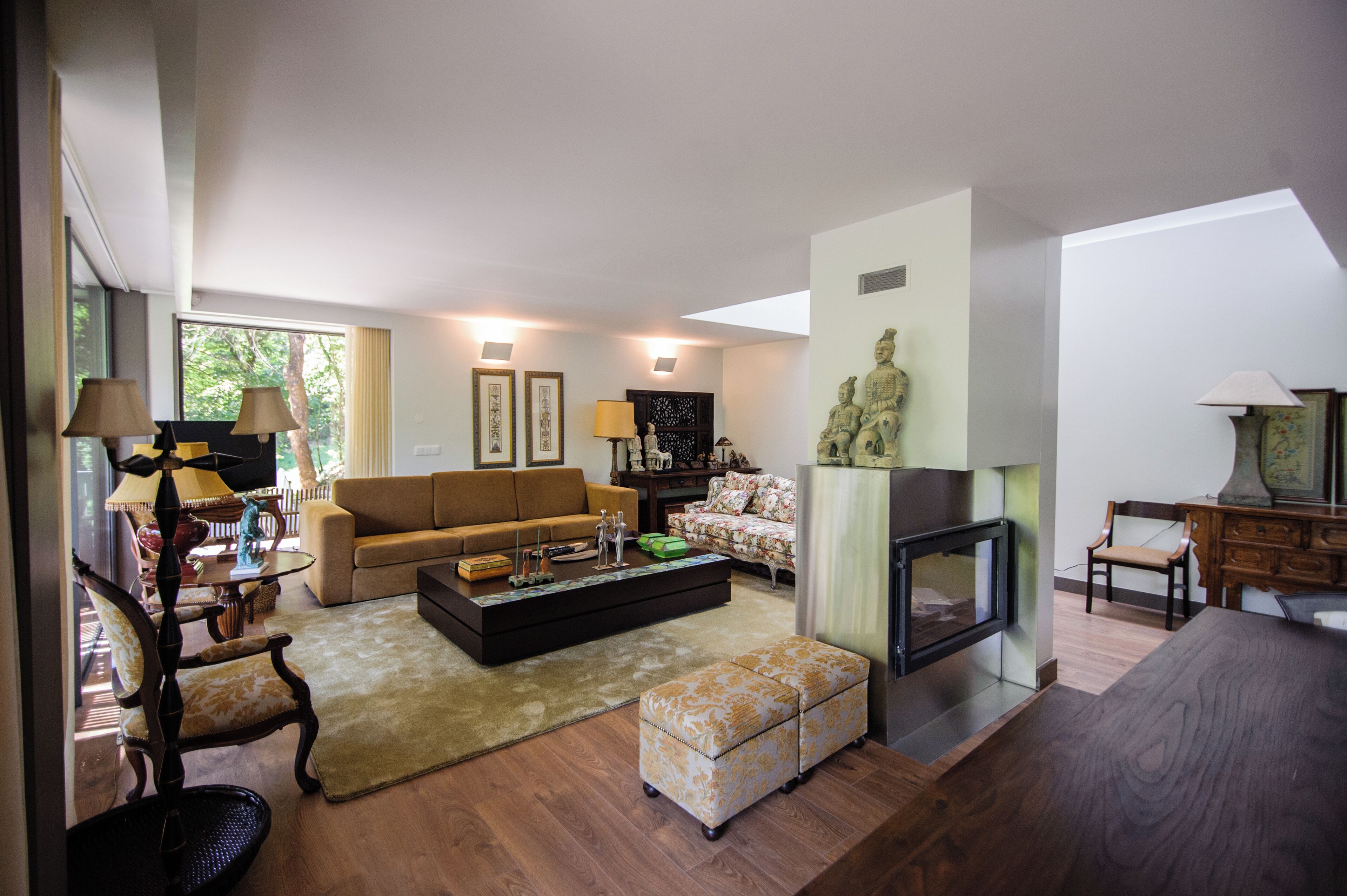 A spacious living room with a sofa, coffee table, and decorative items.