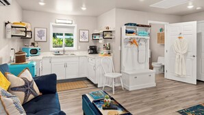 A compact living space with a kitchenette, a dining area, and a bathroom.
