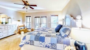 A bedroom with a bed, dresser, chair, and a ceiling fan. - Beautiful Lakefront Lake Anna Views, Dock, Firepit (Mineral)