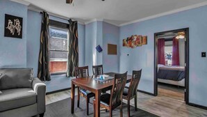 A room with a dining table, chairs, a sofa, and a bed. - Spacious 6-bedroom house with WiFi, AC  and free Parking in brilliant Buffalo (Buffalo)