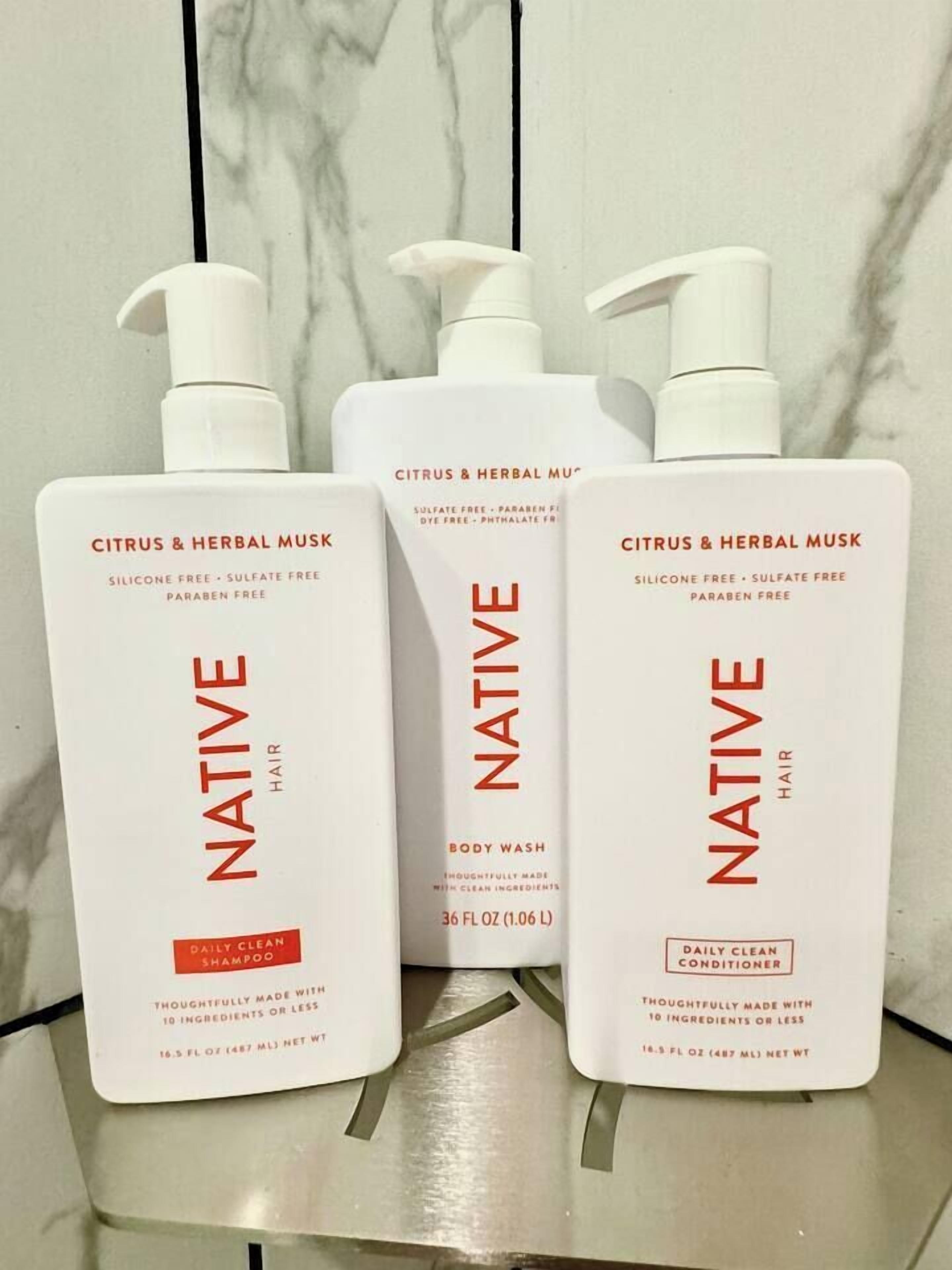 Three bottles of Native hair products with pump dispensers.