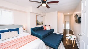 A bedroom with a bed, a sofa bed, a ceiling fan, a painting, and a TV on the wall. - Peaceful Pittsburgh Escape! Mins to North Shore, AGH, PNC Park, Rivers Casino! (Pittsburgh)