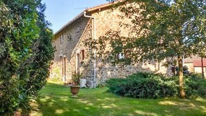 A stone building with a garden in front.