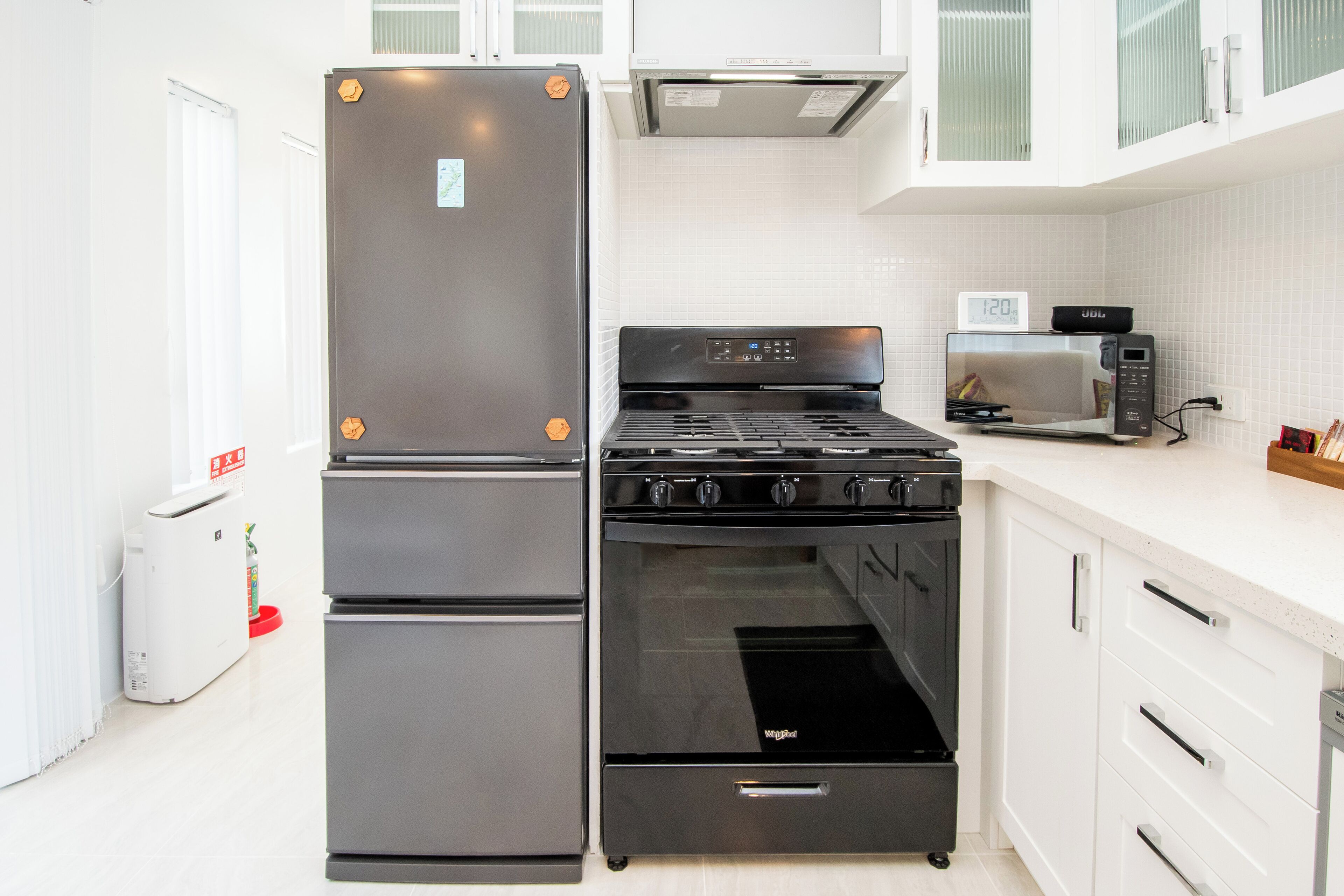 A modern kitchen with a built-in refrigerator, stove, oven, and microwave.