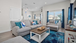 A modern living room with two sofas, a coffee table, and a blue patterned rug. - Coastal Getaway w/ Community Pool + Fishing Nearby (Rockport)