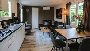 A compact living space with a kitchenette, dining area, and seating area. - Detached Chalet for 5 People in Terwolde (Terwolde)
