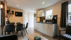 A modern apartment with a dining area, kitchen, and living space. - Detached Chalet for 5 People in Terwolde (Terwolde)