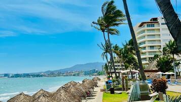 On the beach, sun loungers, beach umbrellas, beach towels