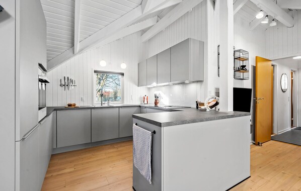Fridge, stovetop, dishwasher, coffee/tea maker