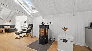 A cozy room with a modern fireplace, a comfortable sofa, and a dining area. - Amazing home in Ansager with WiFi (Ansager)
