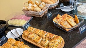 A buffet with various food items including croissants, pastries, and rice. - Pousada Sempre Viva Lençóis (Lençóis)