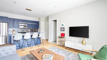 Een modern appartement met keuken, eethoek en woonkamer.